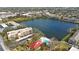 Aerial view showing condo, pool, and lake at 11485 Oakhurst Rd # A301, Largo, FL 33774