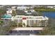 Aerial view of condo building, pool, and parking at 11485 Oakhurst Rd # A301, Largo, FL 33774