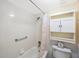 Simple bathroom with shower/tub, toilet, and a linen cabinet at 11485 Oakhurst Rd # A301, Largo, FL 33774