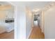 Bright hallway with light wood floors, leading to kitchen and living areas at 11485 Oakhurst Rd # A301, Largo, FL 33774