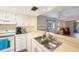 Kitchen sink and countertop with view into living room at 11485 Oakhurst Rd # A301, Largo, FL 33774