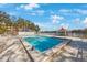 Inviting community pool with lake view and lounge chairs at 11485 Oakhurst Rd # A301, Largo, FL 33774