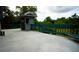 Spacious deck with green railings and surrounding nature views at 12217 Peaceful Ave, Weeki Wachee, FL 34614