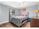 Cozy bedroom with a comfy bed, stained concrete floors, and a ceiling fan at 1232 Calamondin Dr, Holiday, FL 34691