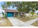 Gray house with teal garage door and driveway at 1232 Calamondin Dr, Holiday, FL 34691