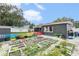 Large garden with various plants and colorful fence at 1232 Calamondin Dr, Holiday, FL 34691