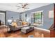 Living room with gray walls, bay window, and stained concrete floors at 1232 Calamondin Dr, Holiday, FL 34691