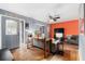 Living room with gray walls, orange accent wall, and stained concrete floors at 1232 Calamondin Dr, Holiday, FL 34691