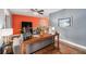 Living room with gray walls, wood console table, and stained floors at 1232 Calamondin Dr, Holiday, FL 34691