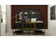 Home office with a large desk, black and gold accents, and a burgundy wall at 13007 Calcite Blue Ave, Wimauma, FL 33598