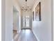 Bright entryway with chandelier, hardwood floors, and white walls at 14610 Horse Trot Rd, Lithia, FL 33547