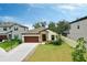 One-story house with a brown door and nicely landscaped front yard at 14610 Horse Trot Rd, Lithia, FL 33547