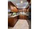 Spacious kitchen featuring granite countertops and dark wood cabinets at 14655 Pine Glen Cir, Lutz, FL 33559