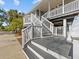 Spacious front porch with white railings and gray flooring at 1538 Riverside Dr, Tarpon Springs, FL 34689