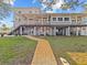 Elevated home with backyard and brick pathway at 1538 Riverside Dr, Tarpon Springs, FL 34689