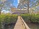 Back of house with walkway leading to waterfront dock at 1538 Riverside Dr, Tarpon Springs, FL 34689