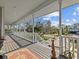 Long covered porch with white railings overlooking the street at 1538 Riverside Dr, Tarpon Springs, FL 34689