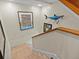 Staircase leading to lower level with artwork at 1538 Riverside Dr, Tarpon Springs, FL 34689