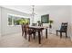 Bright dining room featuring a wooden table, bay window, and hardwood floors at 1621 Park N St, St Petersburg, FL 33710