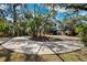 Landscaped circular driveway with lush tropical plants and trees at 1621 Park N St, St Petersburg, FL 33710