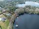 Aerial view of lakefront property showcasing home and private dock at 16320 Rock Lake Dr, Odessa, FL 33556