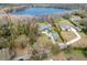 Aerial view of house on lake, large lot, and additional homes nearby at 16320 Rock Lake Dr, Odessa, FL 33556