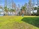 Large grassy backyard with a slide and lake access at 16320 Rock Lake Dr, Odessa, FL 33556