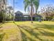 Large backyard with expansive lawn and lake view at 16320 Rock Lake Dr, Odessa, FL 33556