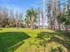 Large grassy backyard with mature trees and lake view at 16320 Rock Lake Dr, Odessa, FL 33556