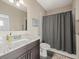 Bathroom with granite countertop, shower and toilet at 16320 Rock Lake Dr, Odessa, FL 33556