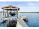 Covered boat lift on wooden dock with lake view at 16320 Rock Lake Dr, Odessa, FL 33556