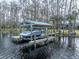 Covered boat lift on a spacious wooden dock at 16320 Rock Lake Dr, Odessa, FL 33556