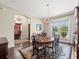 Formal dining room with chandelier, hardwood floors, and rich wood table at 16320 Rock Lake Dr, Odessa, FL 33556