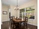 Casual dining area with a chandelier and wooden table, lake view at 16320 Rock Lake Dr, Odessa, FL 33556