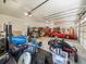 Spacious garage with workshop area, classic car, and equipment at 16320 Rock Lake Dr, Odessa, FL 33556