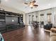 Living room with hardwood floors, large TV and dining area at 16320 Rock Lake Dr, Odessa, FL 33556