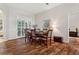 Dining room with wood floors, natural light, and seating for six at 1642 Daylily Dr, Trinity, FL 34655