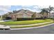 Well-maintained home with a three-car garage, lush landscaping, and manicured lawn on a corner lot at 1642 Daylily Dr, Trinity, FL 34655