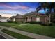 Beautiful home featuring manicured lawn, lush landscaping, and a paved walkway at 1642 Daylily Dr, Trinity, FL 34655