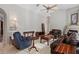 Spacious living room featuring a ceiling fan, tile flooring, and comfortable leather furniture at 1642 Daylily Dr, Trinity, FL 34655