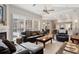 Open-concept living room with plantation shutters, leather furniture, and views into the dining and kitchen areas at 1642 Daylily Dr, Trinity, FL 34655