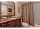 Elegant bathroom with granite vanity, tiled shower, and decorative curtain at 170 Eric Ct, Oldsmar, FL 34677