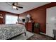 Primary bedroom with king bed, dark walls, and large windows at 170 Eric Ct, Oldsmar, FL 34677