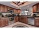 Well-equipped kitchen featuring stainless steel appliances and wood cabinets at 170 Eric Ct, Oldsmar, FL 34677