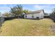 Large backyard with grassy area and privacy fence at 1741 Spinning Wheel Dr, Lutz, FL 33559