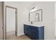 Updated bathroom, featuring a navy blue vanity and a white countertop at 1741 Spinning Wheel Dr, Lutz, FL 33559