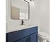 Stylish bathroom featuring a navy blue vanity and a white countertop at 1741 Spinning Wheel Dr, Lutz, FL 33559