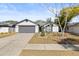 House exterior showcasing gray garage door and front yard at 1741 Spinning Wheel Dr, Lutz, FL 33559