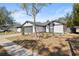 Front view of newly renovated house with gray garage door at 1741 Spinning Wheel Dr, Lutz, FL 33559