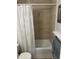 Simple bathroom with a tub shower and neutral tile at 1799 N Highland Ave # 38, Clearwater, FL 33755